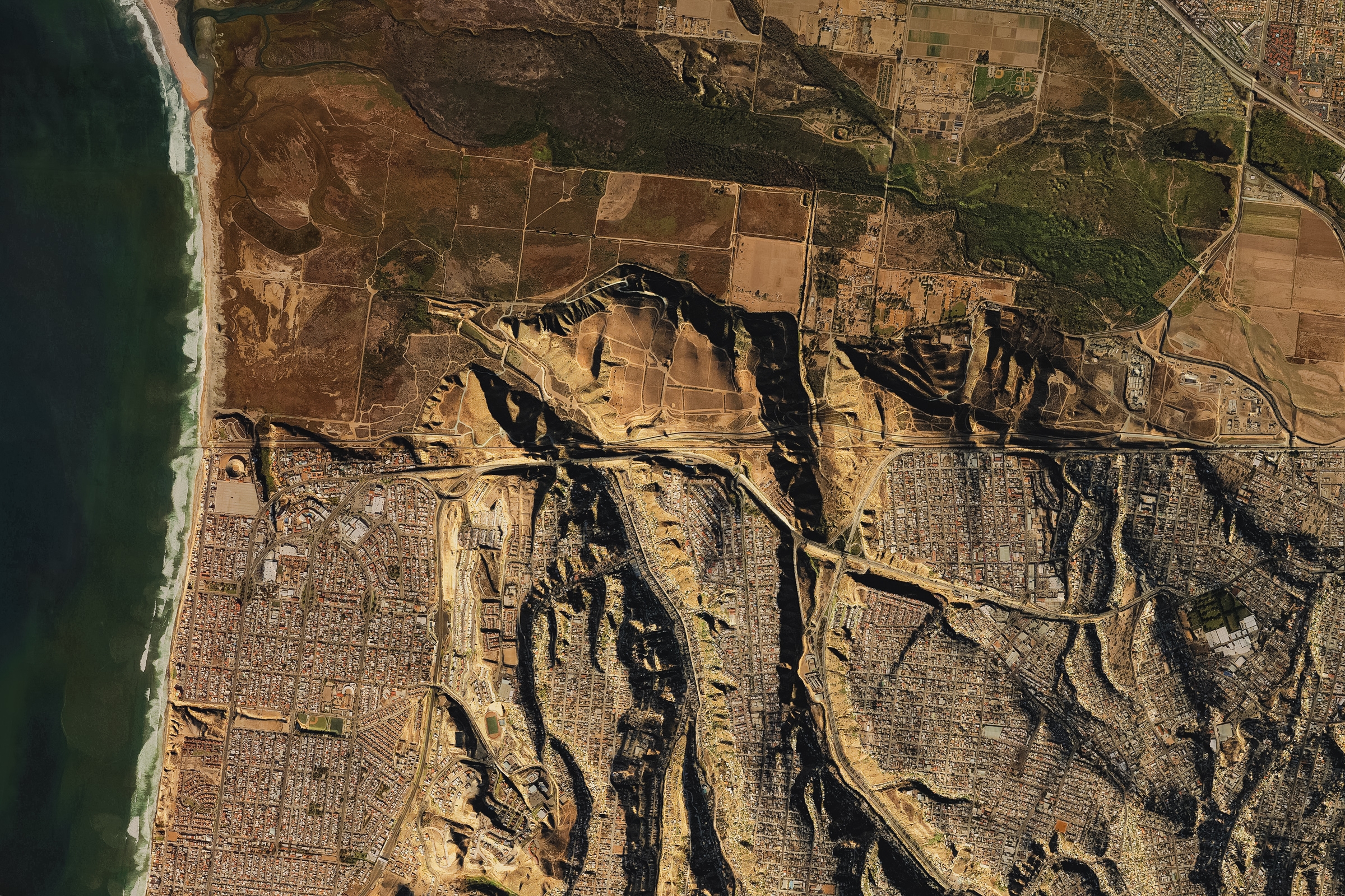 5 of 6, Satellite view of the US–Mexico border wall across the San Diego–Tijuana urban region