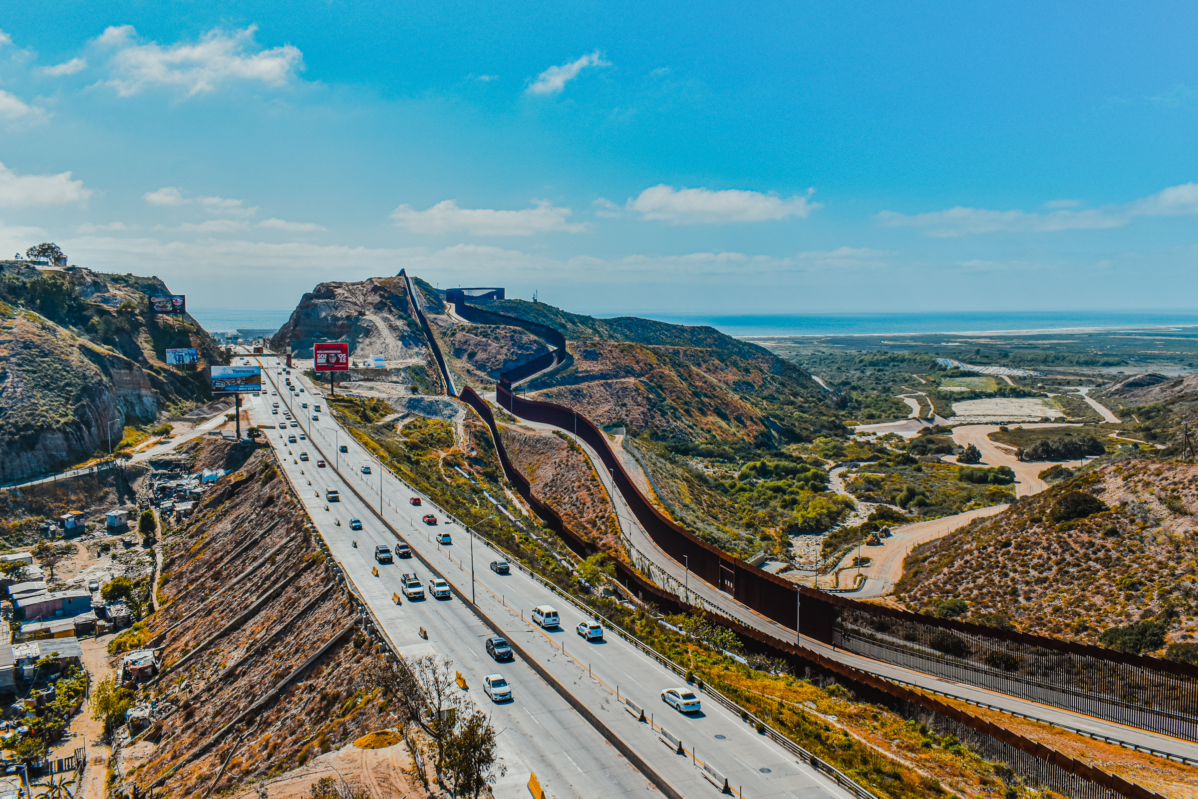 2 of 6, Panoramic view of the US–Mexico border wall where the Laureles Canyon enters the Tijuana River Estuary